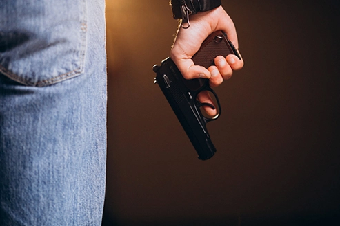 Man discreetly holding a Coatsofsteel concealed carry handgun